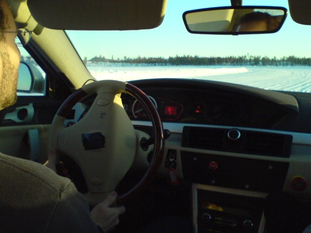 car cornering on ice lake in Sweden with ‘light touch ‘opposite lock steering